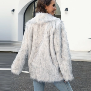 Outdoor shot of ivory faux fox fur coat for women with long sleeves and fluffy texture