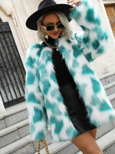 Detailed close-up of blue and white faux fox fur coat texture on outdoor model outfit