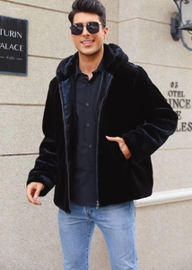 Detail of men's black faux fur hooded jacket with zipper and plush texture in street style