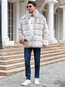 Detail of grey faux fur coat featuring thick plush texture and horizontal layered design