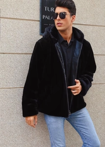 Detail of soft faux fur texture on men's black hooded jacket with zipper closure