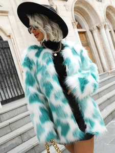 Detail of blue and white contrast faux fox fur coat with a fluffy long-hair texture