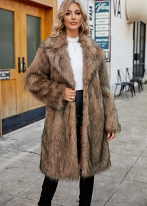 Detailed texture of thick brown faux fox fur coat with large lapels on a fashion model