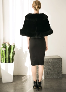Detail view of a luxurious black faux fox fur shawl styled with an elegant back profile