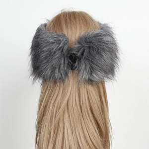 Close-up of thick dark grey faux fox fur headband showing fluffy texture and warmth