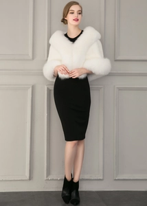 Detail showing plush white faux fur shawl paired with a black elegant evening dress