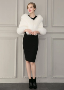 Elegant white faux fox fur shawl wrap for weddings worn over a black dress in interior setting