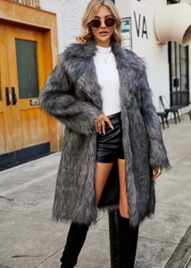 Detail of grey faux fox fur coat with wide lapels and soft long plush texture