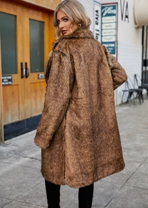 Macro detail of the plush brown faux fox fur coat texture with elegant oversized lapel