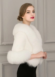 Detail view of white faux fox fur shawl with thick plush trim for formal wedding events