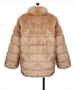 Close-up of premium camel faux fur coat featuring horizontal tiered plush texture