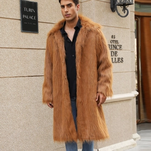 Man wearing a brown long faux fox fur coat standing outside a classic luxury hotel building