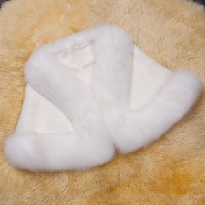 Detailed top view of a white faux fox fur bridal shawl with smooth satin lining texture