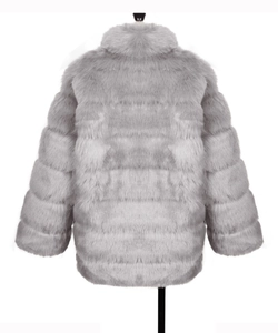 Detailed view of grey faux fur coat featuring horizontal tiered stitching and stand collar