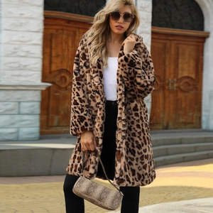 Close-up of stylish leopard print faux fur coat with notched lapels and snakeskin handbag
