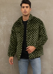 Detail of green checkerboard faux fur jacket showing plush texture and metal zipper