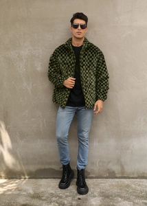 Detail of men's checkered faux fur jacket featuring a high collar and dark green pattern