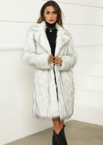 Close-up of luxurious faux fox fur texture and classic wide lapel collar on a white coat