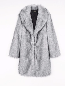 Detail of faux fox fur long coat with large collar and premium brand label on black lining