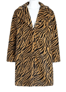 Detailed view of plush faux fur texture with tiger pattern on a tailored lapel coat