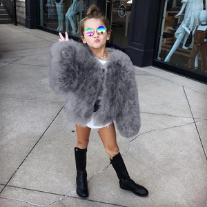 Chic grey faux fur short jacket for children paired with denim shorts and boots
