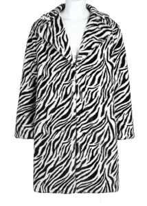 Close-up detail of plush faux fur coat texture with black and white zebra pattern