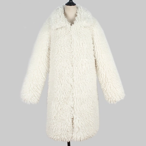 Detailed texture of white faux fur coat featuring a wide lapel and soft plush finish