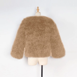 Detail view of the soft faux fox fur texture on this brown collarless kids jacket