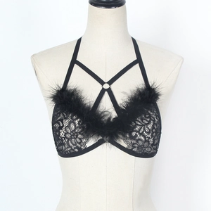 Detail of floral lace bralette featuring black faux feathers and metallic ring hardware