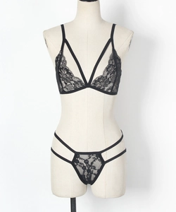 Detail view of black floral lace lingerie set with strappy soft cup bra and thong
