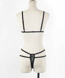 Rear view of black lace lingerie set with adjustable straps and sheer thong on a mannequin