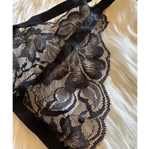 Sexy black floral lace lingerie set with eyelash trim on soft white faux fur background