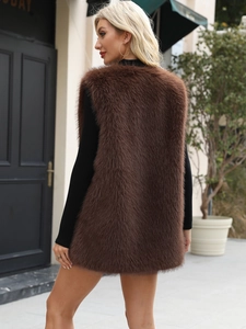Macro texture of soft faux fur on the dark brown long vest for cozy winter styling