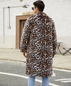 Rear view of a man wearing a long faux fur leopard print coat in a street setting