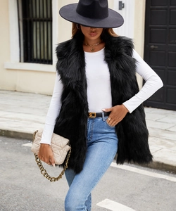 Detailed texture of black faux fox fur vest with a plush long-hair finish and sleek collar