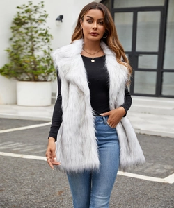 Outdoor street style view of a long white faux fox fur vest with grey tips for women