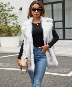 Detail of premium white faux fox fur vest texture with long plush and glossy finish