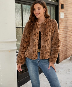 Macro detail of brown faux fur jacket with snake print pattern and round neck