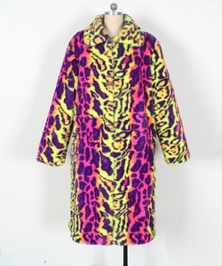 Detailed close-up of vibrant neon leopard print faux fur coat with plush long-hair texture