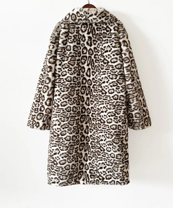 Detail of soft leopard print faux fur texture on a long winter coat with wide lapels