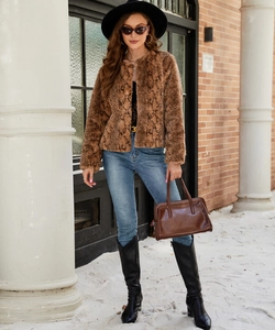 Detail of faux fur cropped jacket featuring brown snake pattern and round neck design