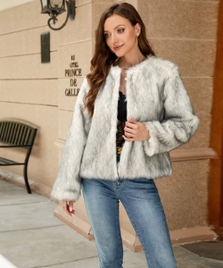 Detail shot of the plush faux fur texture on a cropped jacket worn by a model outdoors