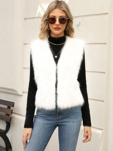 Chic white faux fur vest with deep V-neck worn by a model in an outdoor fashion setting
