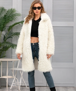 Detail of premium white faux fur texture on elegant long-sleeve winter coat for women