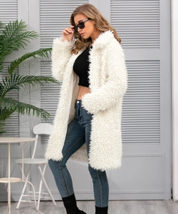 Detail of white faux fur coat showing fluffy long plush texture and premium warm fabric