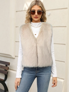 Close-up of fluffy faux fur vest in light beige texture with elegant V-neck detail