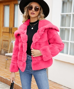Close-up of fluffy rose red faux fur coat showing soft plush texture and large lapel detail