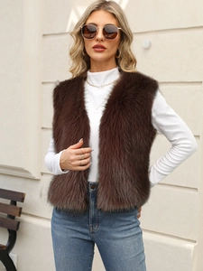 Faux fur vest in dark brown plush finish layered over a white long-sleeve top