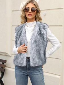 Close-up of grey faux fur vest texture styled with a white turtleneck and gold necklace