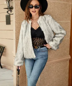 Detail of faux fur texture on a cropped cream jacket paired with a fashion belt